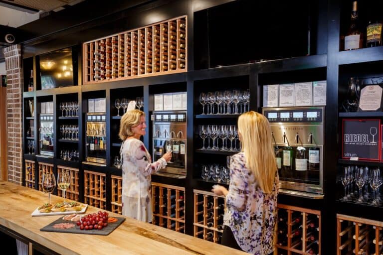 Visitors exploring a sophisticated wine bar as part of their Kiawah Island nightlife experience, as suggested by the Visit Kiawah Island Guide.