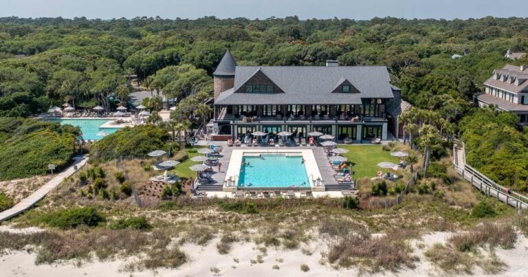 Aerial view of the KICA Homeowners Association Building and its luxurious pool, nestled among Kiawah Island's verdant landscape, as featured in the guide.