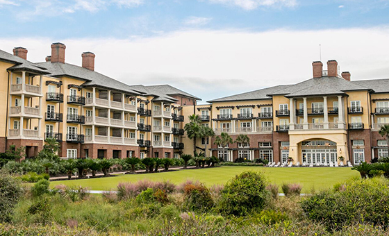 The elegant facade of The Sanctuary Resort at Kiawah Island, showcasing luxury accommodation amidst lush landscapes.