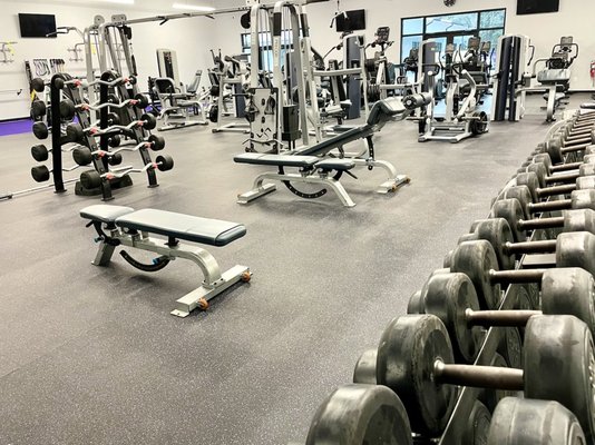 A well-equipped gym featuring weights and machines, part of the amenities at Kiawah Island as noted in the Visit Kiawah Island Guide.