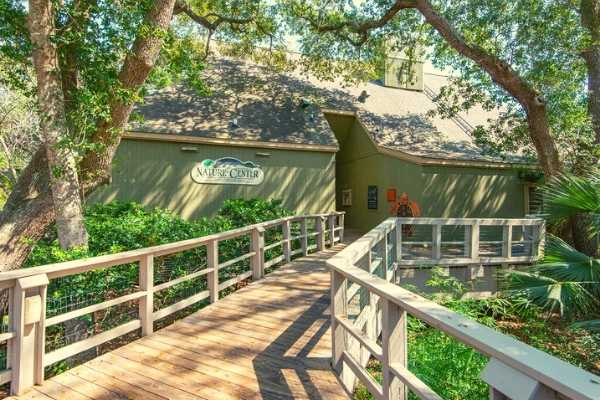 The entrance to Kiawah Island Nature Center, nestled amidst lush greenery, inviting visitors to explore local wildlife and natural attractions.