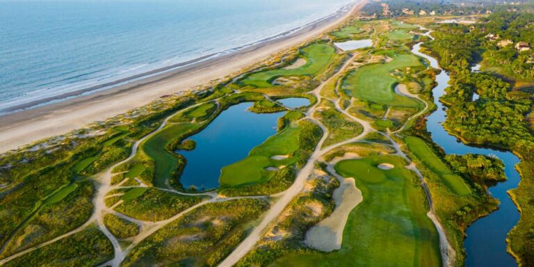 Aerial view of The Ocean Course at Kiawah Island showcasing the lush greens adjacent to the sandy beach.