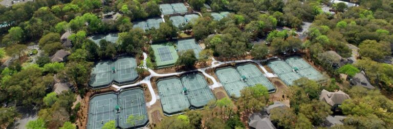 Overhead view of Roy Barth Tennis Center on Kiawah Island with multiple tennis courts nestled among lush trees.