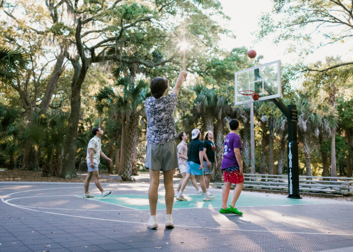 Teens playing basketball surrounded by Kiawah Island's natural beauty, part of the engaging Kiawah Island Teens Programs for ages 12-17.