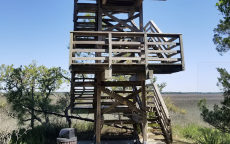 Wooden observation tower at Kiawah Island offering panoramic views of the marshland, a place to visit for breathtaking scenery.