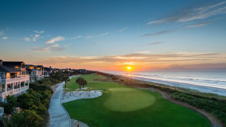 Sunset over Turtle Point Golf Course on Kiawah Island with a picturesque view of the green and beachfront homes